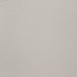 Close-up of the Cradle Pique Performance Long Sleeve Sweatshirt by PETER MILLAR in light beige, featuring textured piqué fabric and the visible brand label at the neckline. Size: medium. Made in India.