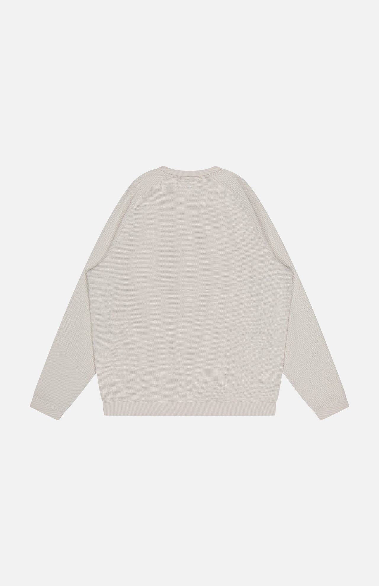 The PETER MILLAR Cradle Pique Performance Long Sleeve Sweatshirt in light beige is shown flat on a white background, featuring a plain textured back with no visible patterns, logos, or designs.