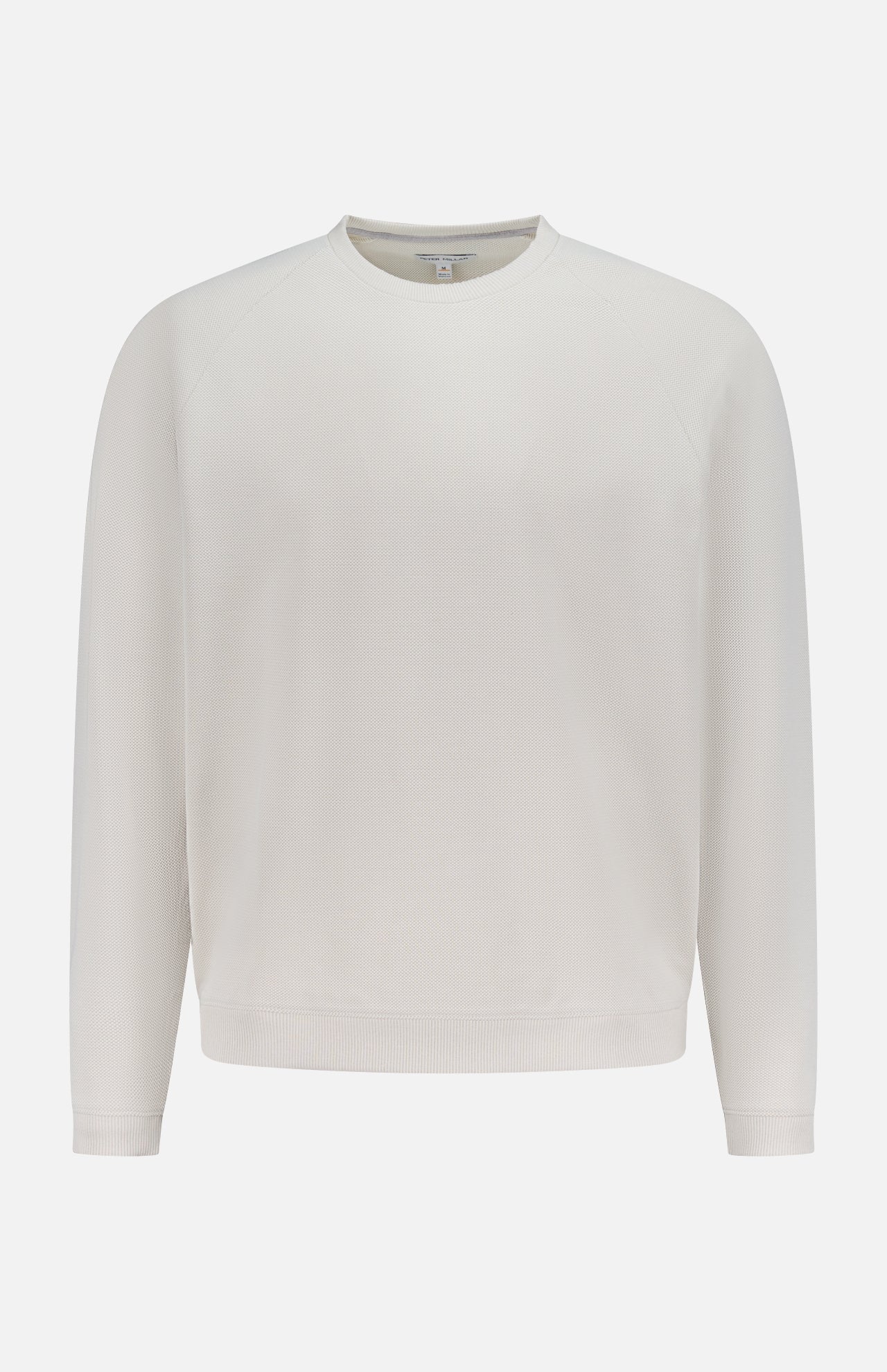 The PETER MILLAR Cradle Pique Performance Long Sleeve Sweatshirt features a relaxed fit, off-white textured piqué fabric, subtle four-way stretch, and long sleeves, shown against a white background.
