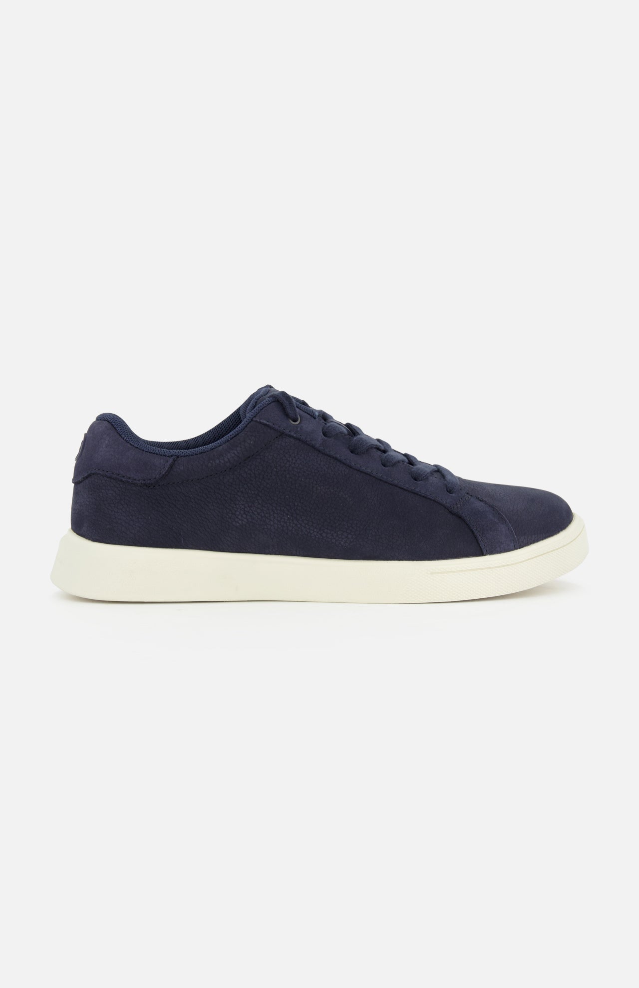The PETER MILLAR Drift Classic Nubuck Sneaker is a men's navy court shoe with matching laces and a white rubber sole, displayed in a side view against a plain white background.