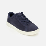 The Drift Classic Nubuck Sneaker by PETER MILLAR is a men's navy leather court sneaker with matching laces and a white rubber sole, shown on a plain light background and angled slightly to the right.