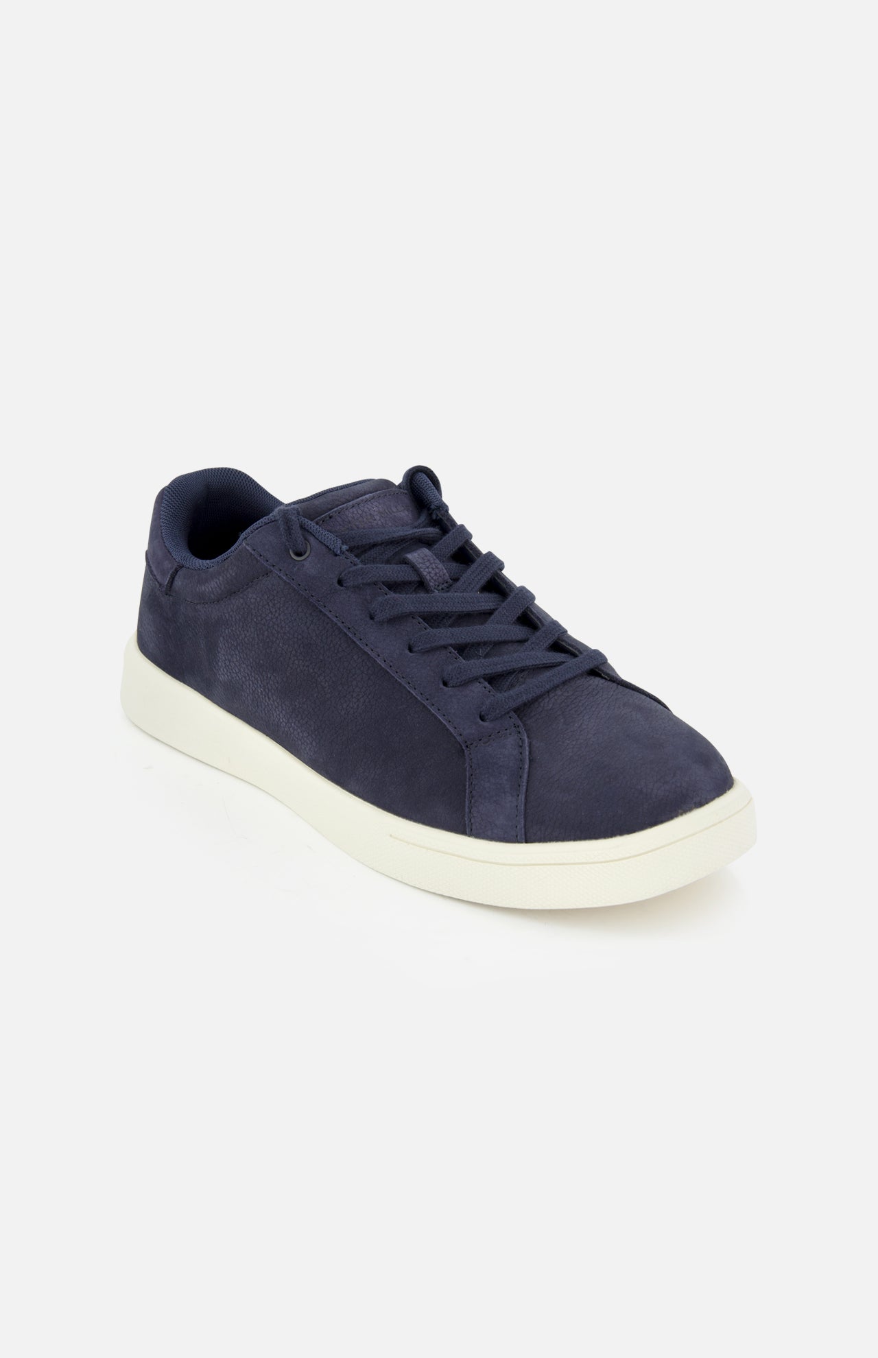The Drift Classic Nubuck Sneaker by PETER MILLAR is a men's navy leather court sneaker with matching laces and a white rubber sole, shown on a plain light background and angled slightly to the right.