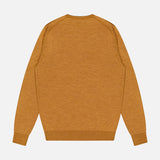 The image shows the back view of the Excursionist Flex Crewneck Sweater by PETER MILLAR in mustard yellow, featuring long sleeves and a classic crew neckline, laid flat on a white background—an ideal choice for stylish travel on cooler days.
