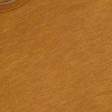 Close-up of the Excursionist Flex Crewneck Sweater in an orange-brown hue, highlighting the collar detail and a tag displaying the PETER MILLAR brand and size information. The fabric looks soft with a subtly heathered finish, evoking the comfort of merino wool—ideal for travel or everyday wear.