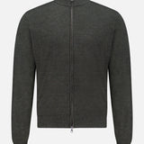 The PETER MILLAR Excursionist Flex Full Zip Sweater is a dark gray, long-sleeve knitted merino wool sweater with a stand collar, displayed against a white background. This full-zip sweater features a full-length zipper along with ribbed cuffs and hem.