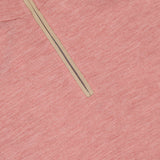 A close-up of the PETER MILLAR Excursionist Flex Quarter-Zip Sweater in pink heathered merino wool, highlighting the collar and beige zipper detail on a flat surface.