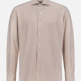 The Excursionist Flex Stripe Sport Shirt by PETER MILLAR is a brown and white vertically striped, long-sleeve button-up shirt with a collar, crafted from wrinkle-resistant cotton-stretch fabric for all-day comfort and easy care. Displayed on a plain white background.