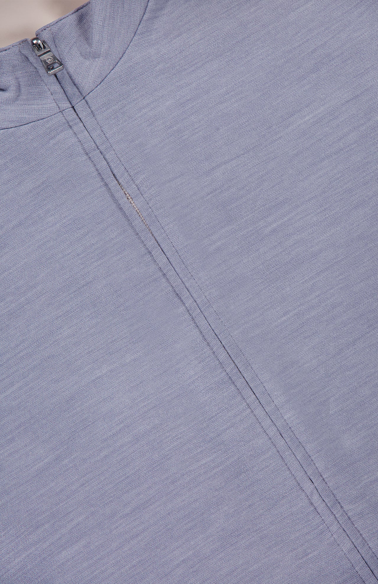 Close-up of the Ryder Reversible Water Resistant Vest by PETER MILLAR in light purple merino wool-blend, featuring a visible front zipper and a subtle seam detail parallel to the zipper.