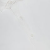 The PETER MILLAR Seaward Cotton Lyocell Sport Shirt is a lightweight white shirt with a subtle textured pattern, open collar, button-up front, and a visible brand label inside the neck.