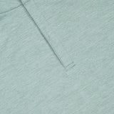 Close-up of the PETER MILLAR Stealth Performance Quarter-Zip Pullover in light green, featuring neat stitching, UPF 50+ sun protection fabric, and premium textured details.