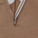 Close-up of the Stealth Performance Quarter-Zip Sweater by PETER MILLAR, showcasing its brown lightweight fabric, quarter-zip neckline with a partially unzipped silver zipper, light gray inner lining, and a navy collar tag.
