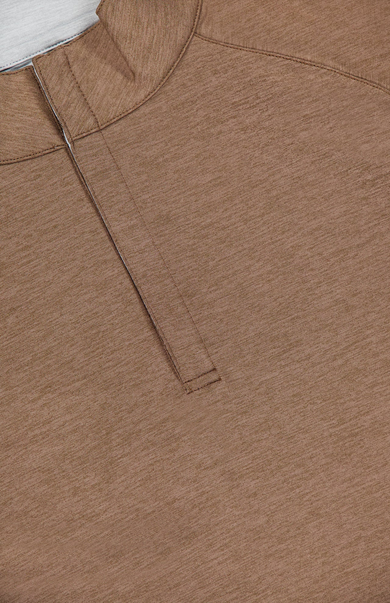 Close-up of the PETER MILLAR Stealth Performance Quarter-Zip Sweater in brown, featuring a hidden placket and collar, laid flat on a white surface. The subtly textured fabric and precise stitching along the seams and placket are visible. This lightweight pullover combines everyday style with exceptional comfort.