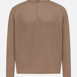 The Stealth Performance Quarter-Zip Sweater by PETER MILLAR is a light brown, long-sleeve, lightweight pullover featuring a short stand collar and a partial front zipper with a quarter-zip neckline for versatile styling, displayed against a plain white background.