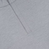 Close-up of the PETER MILLAR Stealth Stripe Performance Quarter-Zip Sweater in light gray, showcasing its lightweight design with a subtle pinstripe texture. Features include a partially visible collar and a vertical quarter-zip near the neckline, crafted with four-way stretch fabric for comfort and mobility.