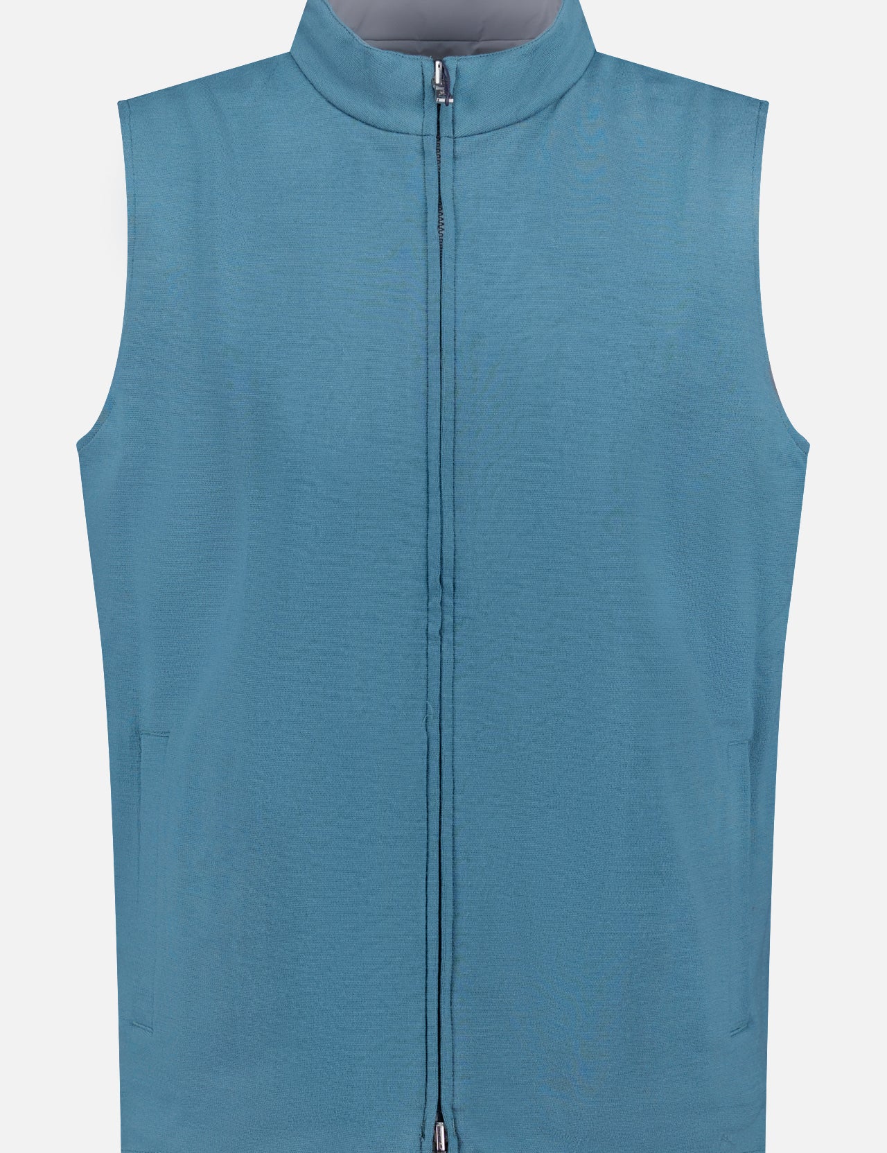 The PETER MILLAR Ryder Water-resistant Reversible Vest is a sleeveless, light blue vest with a high collar and two side pockets, shown against a plain white background.