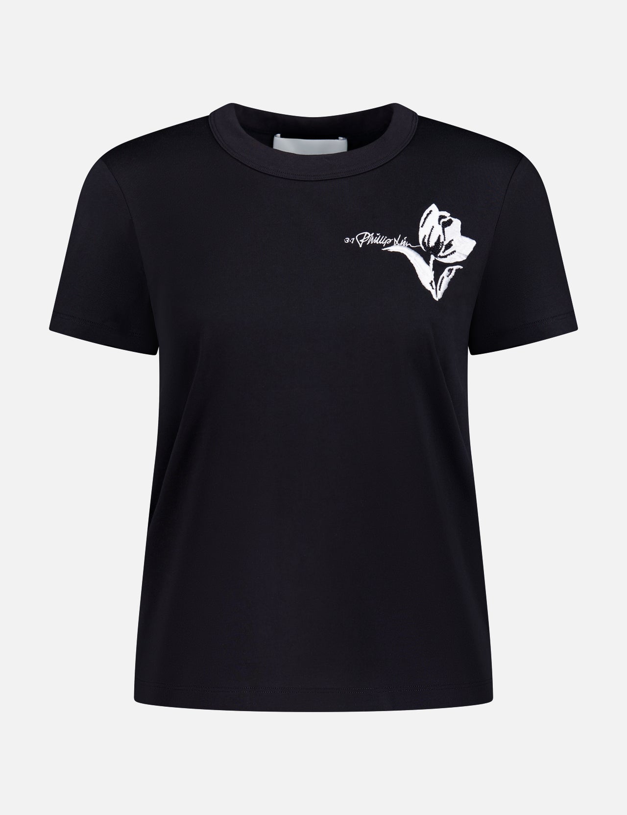 The 3.1 PHILLIP LIM Cropped Short Sleeve T-shirt features a black design with a white abstract floral graphic and cursive text on the upper left chest, shown against a plain white background.
