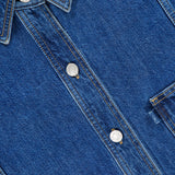 Close-up of the 3.1 PHILLIP LIM Oversized Denim Shirt Jacket in blue, highlighting metal buttons, yellow stitching, a collar, and part of the chest pocket. The fabric texture and detailed stitching are clearly visible.