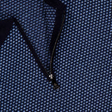 Close-up of a textured blue and black PIACENZA 1/4 Zip Knit Polo Shirt with a small repeating pattern. A label at the collar signals designer quality, while the zipper reveals more of its intricate knit.