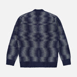 The PIACENZA Combed Pixel Stripe Crewneck Sweater is a fuzzy, long-sleeve blue virgin wool knit with dark blue and gray pixelated stripes, shown flat, back view on a white background.