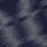 Close-up of a soft, fuzzy blue Combed Pixel Stripe Crewneck Sweater in virgin wool with a rounded neckline. A white PIACENZA label is partially visible at the top left corner.