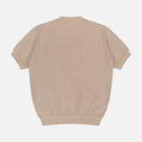 The PIACENZA Crewneck Short Sleeve Knit Sweater in tan silk cotton, made in Italy, is shown laid flat from the back. It features a ribbed texture, crew neckline, and ribbed cuffs and hem.