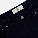 Close-up of the waist area of dark navy 1000 Wales Stretch Denim Jeans by PT TORINO, expertly crafted in Italy, showing a metal button, front pockets, belt loops, and a white label with PT TORINO printed on it.