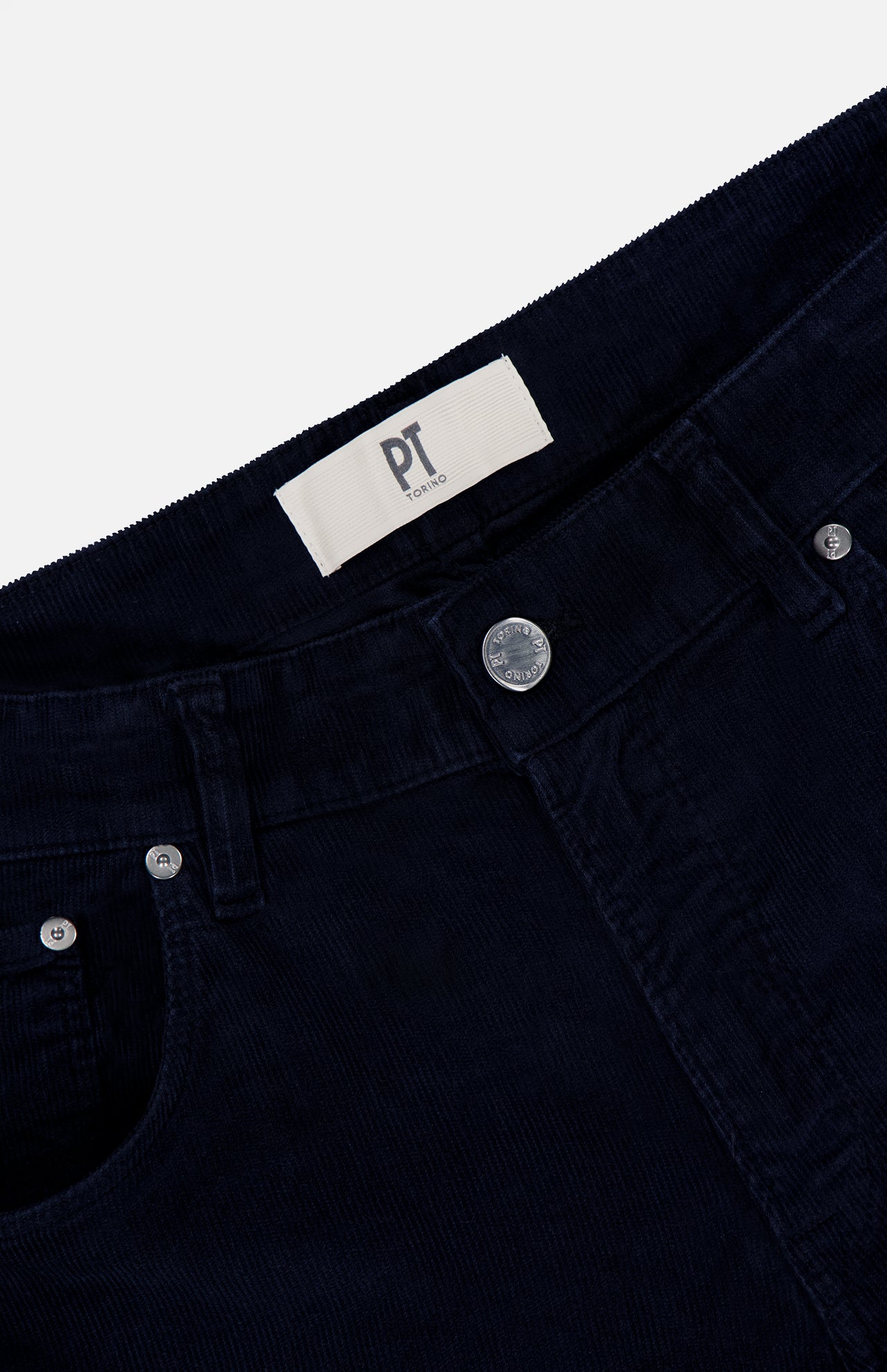 Close-up of the waist area of dark navy 1000 Wales Stretch Denim Jeans by PT TORINO, expertly crafted in Italy, showing a metal button, front pockets, belt loops, and a white label with PT TORINO printed on it.