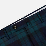 Close-up of the PT TORINO Clan Heritage Wool Tartan Trouser Pants in blue and green, featuring the waistband, belt loops, button, and part of the fly against a light gray background. These slim fit trousers showcase detailed construction that blends style and comfort with their fleece wool material.
