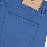 Close-up of the back pocket and waistband of the Cotton-Cashmere Stretch Tricotine Jeans in Azzurro by PT TORINO, showcasing a classic 5-pocket design with a beige leather PT TORINO patch above the pocket.