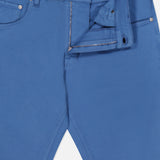 Sure! Here’s a rewritten sentence using your product data: The Cotton-Cashmere Stretch Tricotine Jeans in Azzurro from PT TORINO feature a classic five-pocket design, visible belt loops and pockets, a metal button at the waistband, and a zipper fly partially open. The label inside the waistband displays the letters “PT.” Crafted from a luxurious blend of cotton and cashmere, these jeans offer timeless style with exceptional comfort.