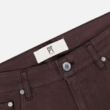 Close-up of the waistband and upper portion of PT TORINO Stretch Jeans in Testa Di Moro, featuring front pockets, a silver button, and a white PT TORINO label on the inner waistband.