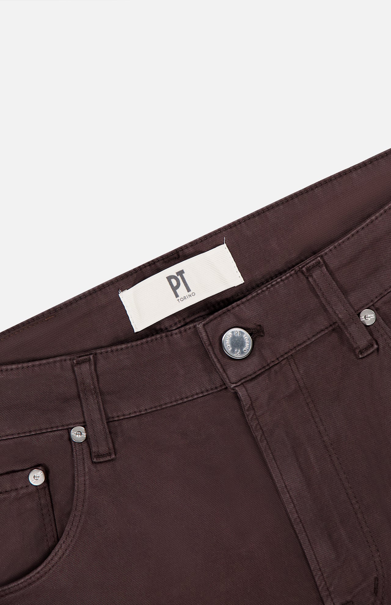 Close-up of the waistband and upper portion of PT TORINO Stretch Jeans in Testa Di Moro, featuring front pockets, a silver button, and a white PT TORINO label on the inner waistband.