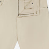 PT TORINO’s Cotton & Cashmere Stretch Tricotine Jeans in Stone showcase a visible zipper and button fly, partially unzipped to display the waistband and part of the inside label. Crafted in Italy from a luxe cotton-cashmere blend, these jeans feature a classic 5-pocket design.