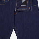 Dark blue PT TORINO Cotton Denim Stretch Jeans with orange stitching, partially unzipped to show the zipper, fly, metal waistband button, and inside label featuring classic Italian style and craftsmanship.