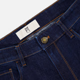 Close-up of PT TORINO Cotton Denim Stretch Jeans in dark blue, featuring orange stitching, a metal button, belt loops, and a white PT TORINO label inside the waistband.