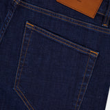 Close-up of the back pocket on PT TORINO Cotton Denim Stretch Jeans in dark blue, with a brown leather patch on the waistband, stitched details, and a subtle brand logo.