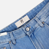 Close-up of PT TORINO Denim Stretch Jeans in light blue with a vintage wash, featuring waistband, belt loops, metal button, zipper, front pockets, and a fabric label with "PT" in black. Jeans are laid flat on a white background.