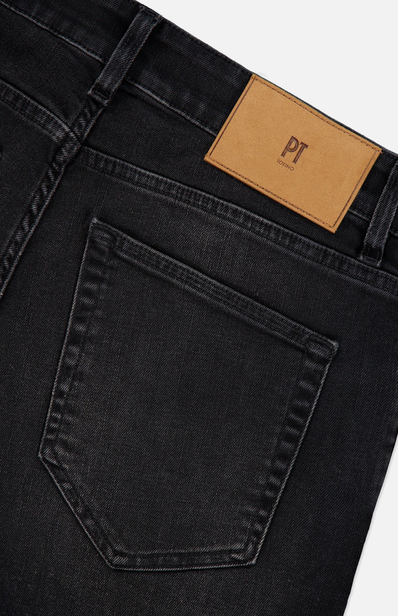 Close-up of the back of the Jazz Denim Stretch Jeans by PT TORINO in black, featuring a single rear pocket and a tan leather patch with “PT TORINO” embossed on the waistband.