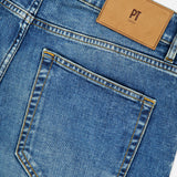 Close-up of the back pocket and waistband of the PT TORINO New Denim 5-Pocket Jeans in stretch blue denim, featuring a brown leather patch labeled PT TORINO above the pocket.