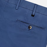Close-up of the back of PT TORINO Slim Flat Front Garment Dyed Trouser Pant in blue cotton silk blend, featuring a single welt pocket with brown button, belt loops, part of waistband, and a smooth, slightly shiny finish.