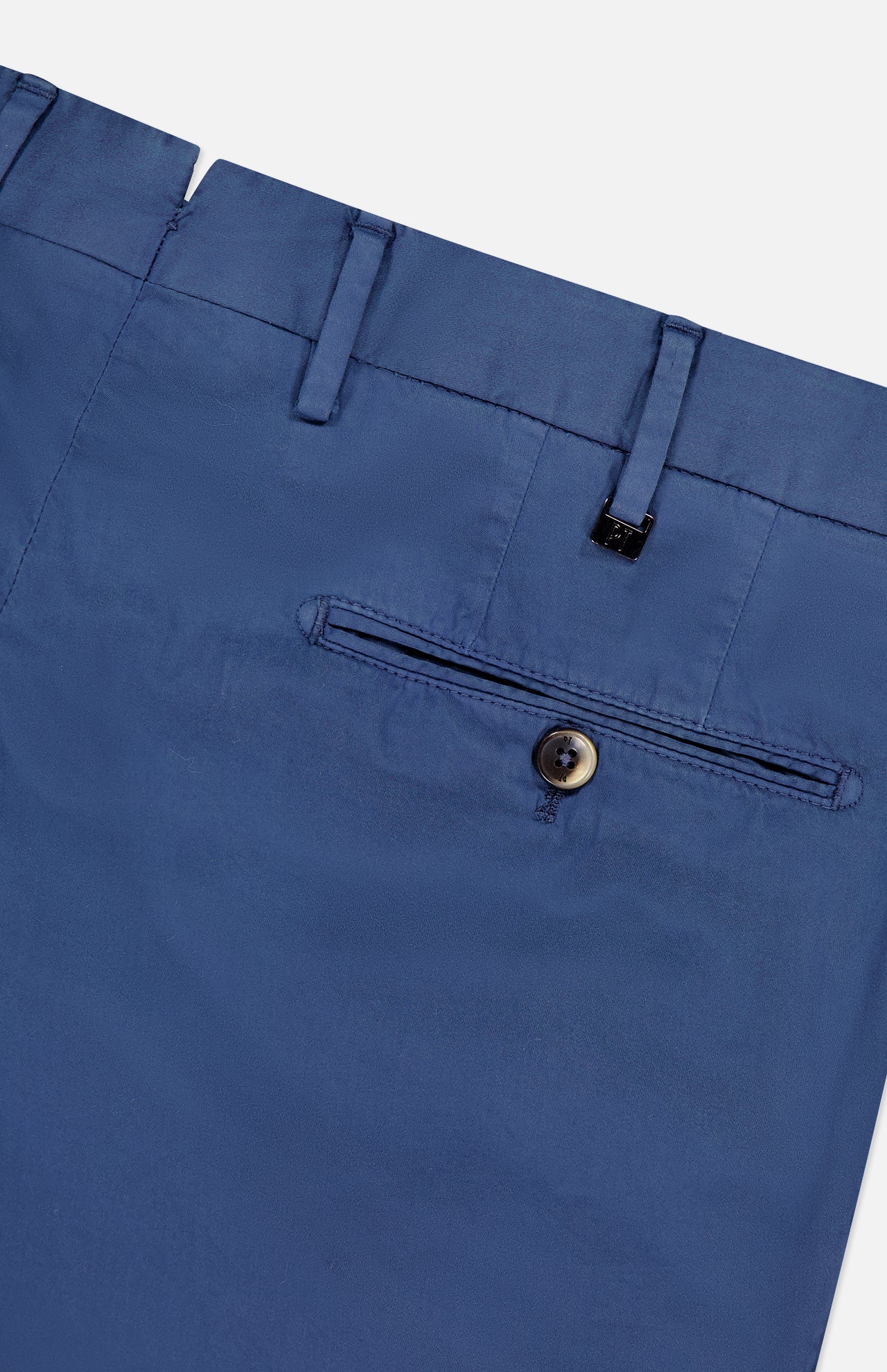 Close-up of the back of PT TORINO Slim Flat Front Garment Dyed Trouser Pant in blue cotton silk blend, featuring a single welt pocket with brown button, belt loops, part of waistband, and a smooth, slightly shiny finish.