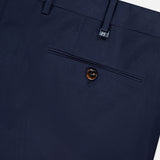 Close-up of PT TORINO Slim Flat Front Stretch Fine Twill Trouser Pant in navy, featuring a back pocket with brown button, belt loop, and waistband detail against a light background.