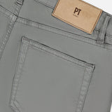 Close-up of the back of PT TORINO Soft Stretch Gabardine Pants in Grigio, featuring a large back pocket and a tan leather brand label near the waistband, highlighting refined Italian style.