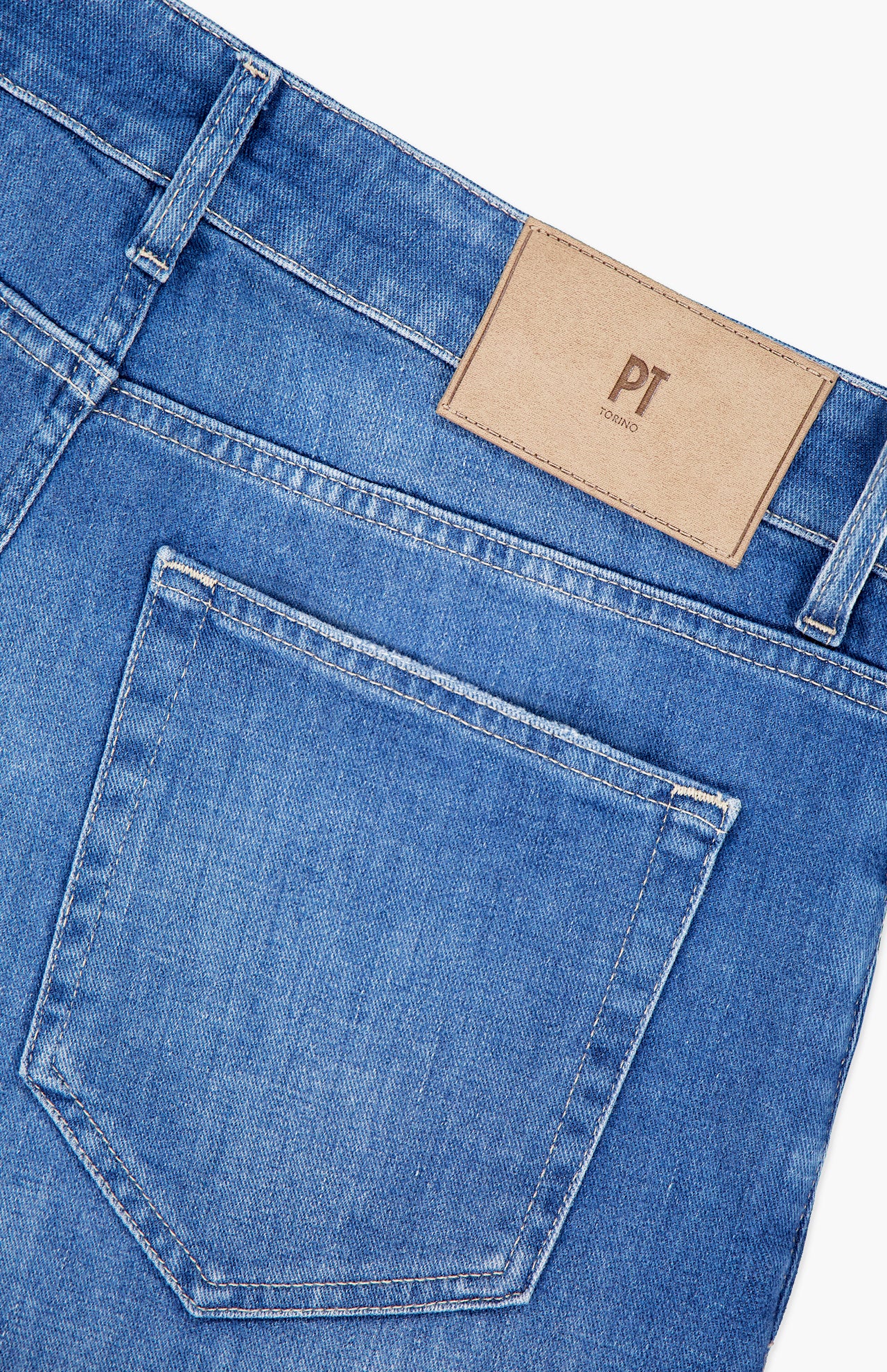 Close-up of the back of PT TORINO Soft Touch Light Stretch Jeans, showing a single back pocket and a tan leather patch with PT TORINO initials embossed near the waistband, made from comfortable stretch denim.