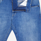 The PT TORINO Soft Touch Light Stretch Jeans feature a fly left unzipped and waistband unbuttoned, subtly displaying the white pocket lining and inner waistband for a relaxed look.