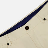 Close-up of the waistband and upper section of PT TORINO Stretch Clean Silkochino Pants in off-white, showing belt loops, front pockets, a dark button, blue inner lining, and classic 5-pocket design.