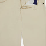 PT TORINO Stretch Clean Silkochino Pants in beige cotton-silk, shown partially unzipped to reveal a blue-white striped inner waistband. Features include front pockets, a minimal look, and classic 5-pocket styling.