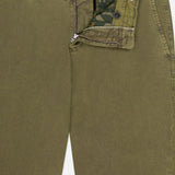 PT TORINO Stretch Fine Canvas Trouser Pants in olive green cotton feature a slim fit, belt loops, casual worn-in texture, and a partially open zipper and button showing an inner green camouflage waistband.