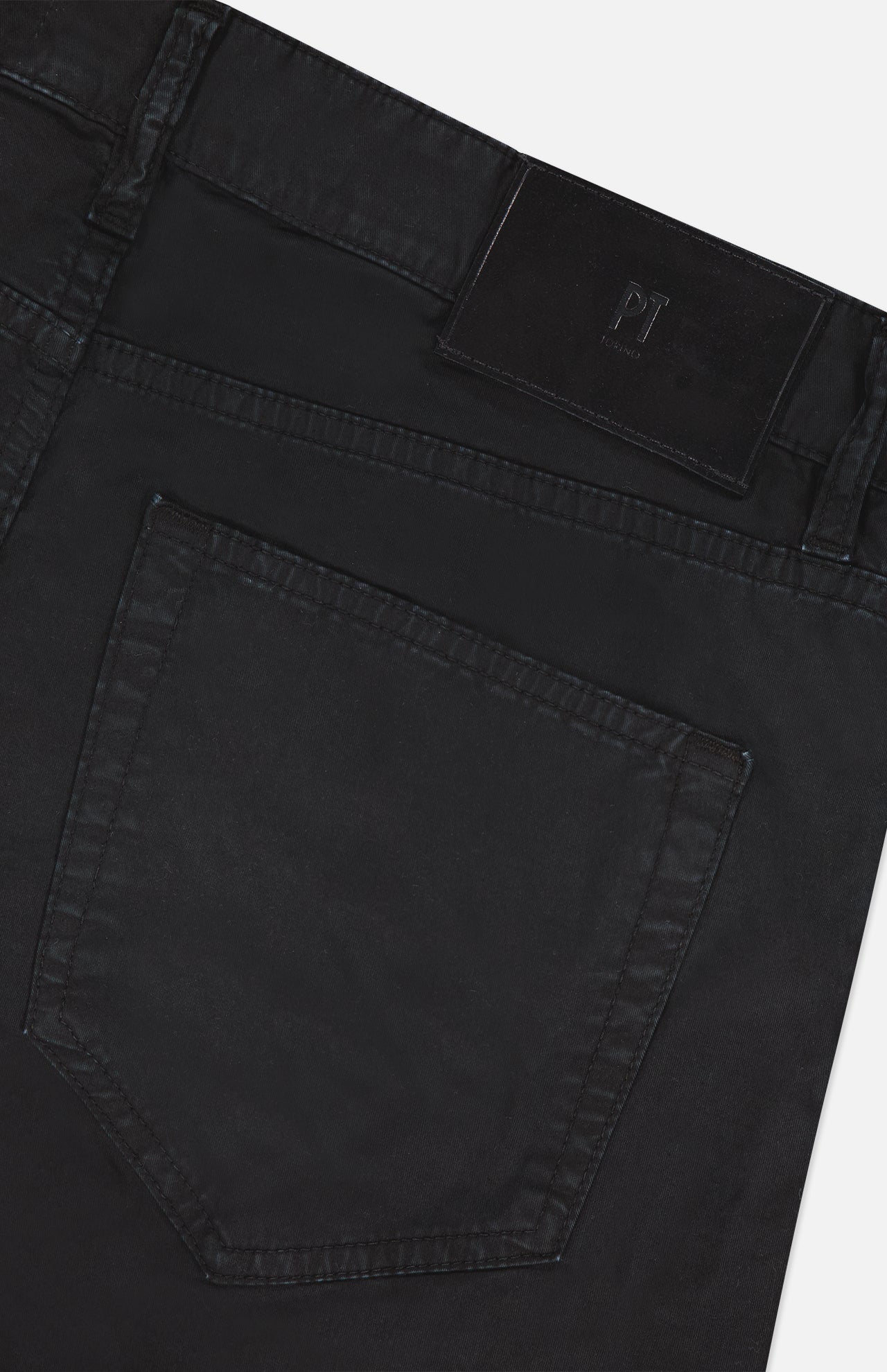 Close-up of the back pocket of PT TORINO Stretch Gabardine 5-Pocket Pants in black, featuring visible stitching, a black leather brand patch near the waistband, and classic 5-pocket detailing.