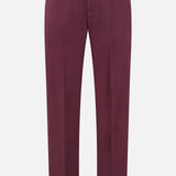 The PT TORINO Stretch Overdyed Solaro Trouser Pant features a rich maroon hue, complete with belt loops, a front button and zip closure, and is crafted from a comfortable cotton-blend fabric—ideal for professional dressing. Shown against a white background.